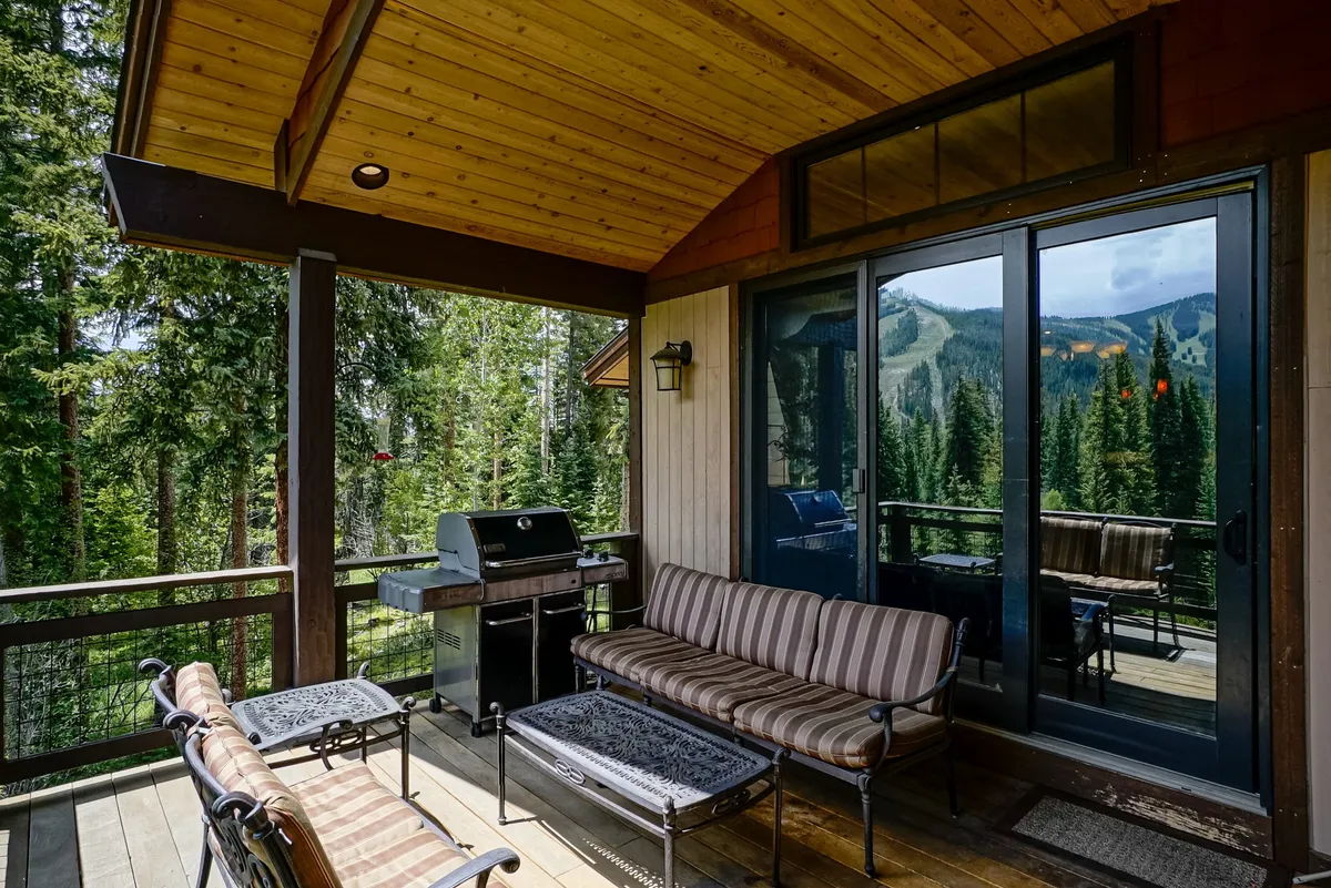 An outdoor seating area with comfortable chairs and a grill, set against a scenic backdrop. The space feels casual yet inviting, encouraging families to socialize, enjoy a barbecue, or simply relax while taking in sunset views.